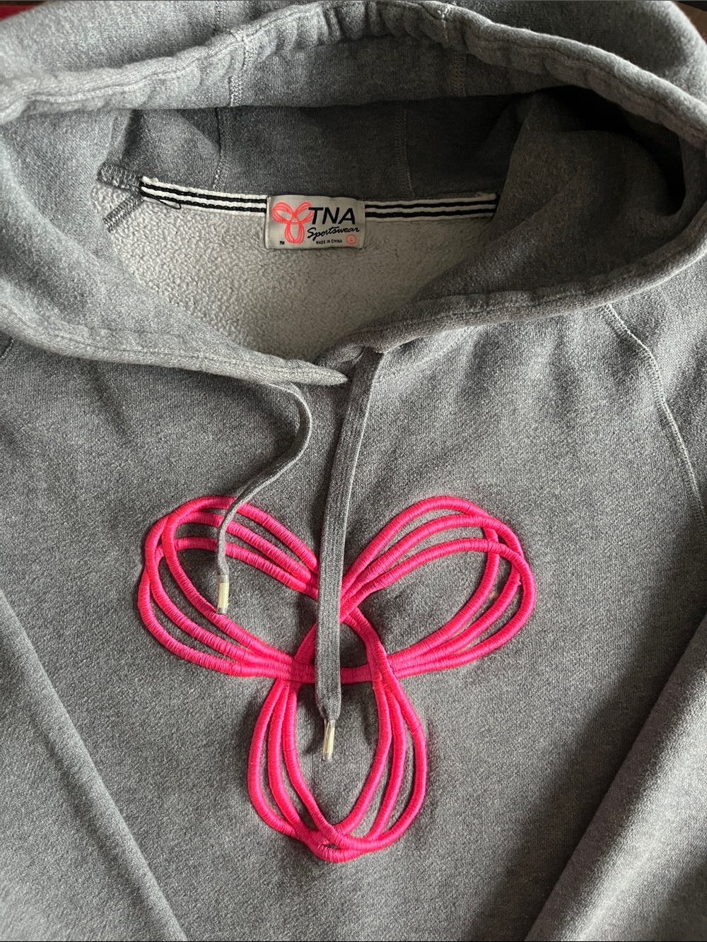 TNA Gray Hoodie with Bright Pink Cord Detail